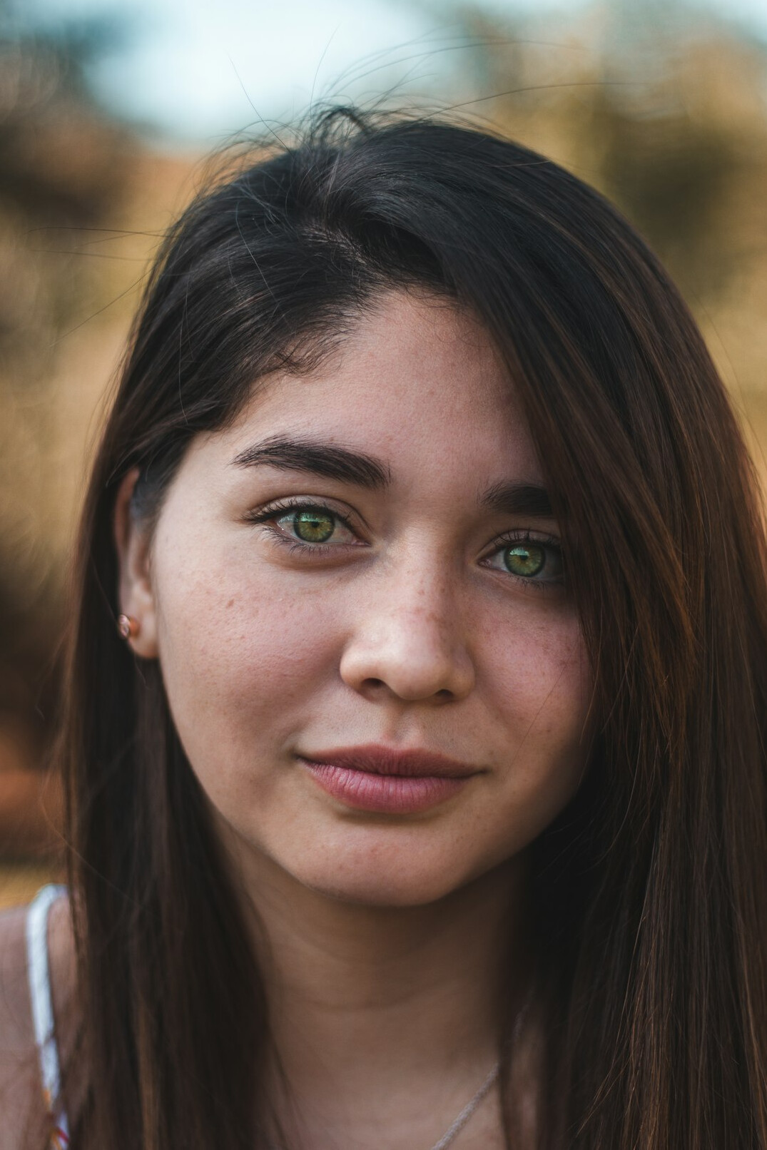 Portrait of a young woman with brown hair smiling
