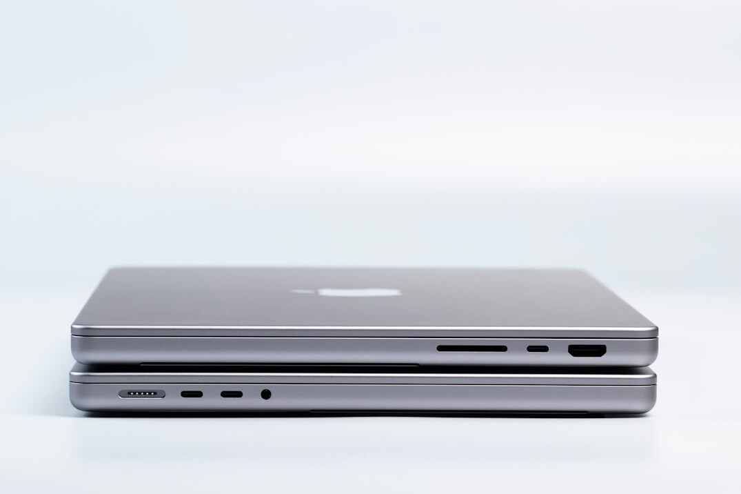 Laptop and notebook on a white desk